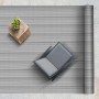 Grau gestreifter KARAT Outdoor Teppich Bologna (180x200 cm) mit Stuhl und Tisch auf Terrasse.