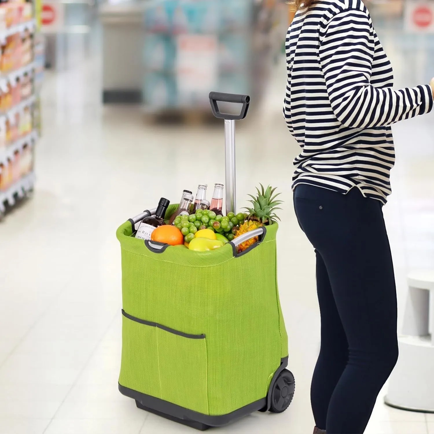 Grüner, klappbarer 50L Einkaufstrolley mit Teleskopgriff, gefüllt mit Lebensmitteln, wird im Supermarkt gezogen.