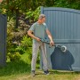 Mann reinigt Gartentor mit Gardena Akku-Multi-Reiniger AquaBrush Patio. Inkl. Akku.