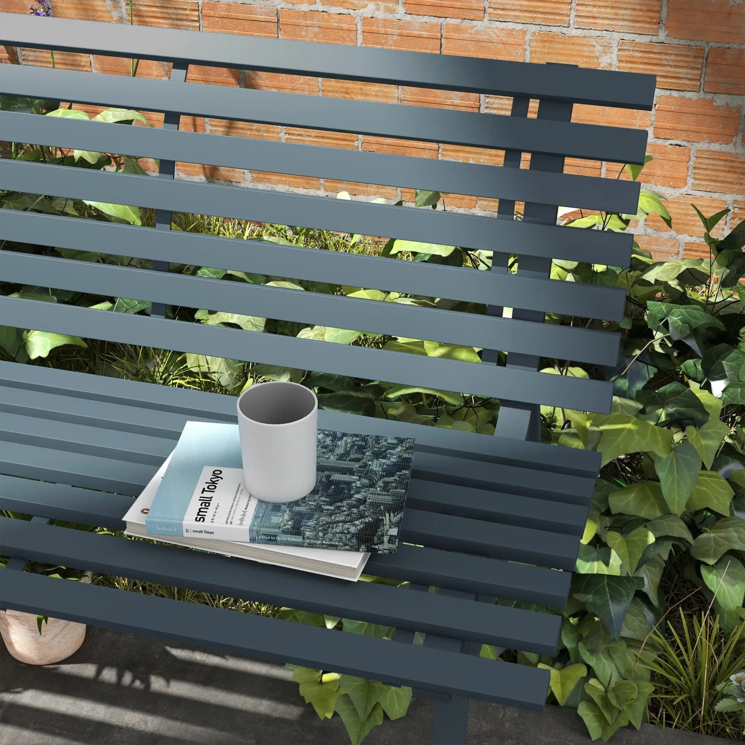 Blaue Outsunny Gartenbank aus Aluminium mit Buch und Tasse auf der Sitzfläche.