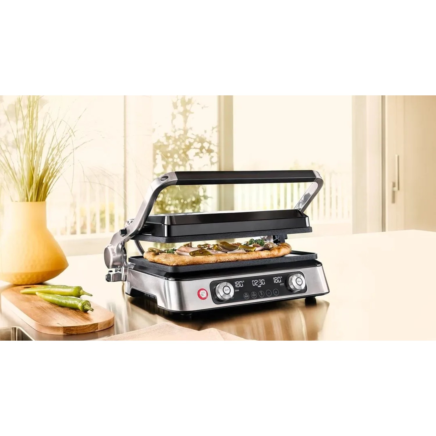 Braun Multigrill 9 Pro Kontaktgrill in Silber mit Pizza im geöffneten Zustand.