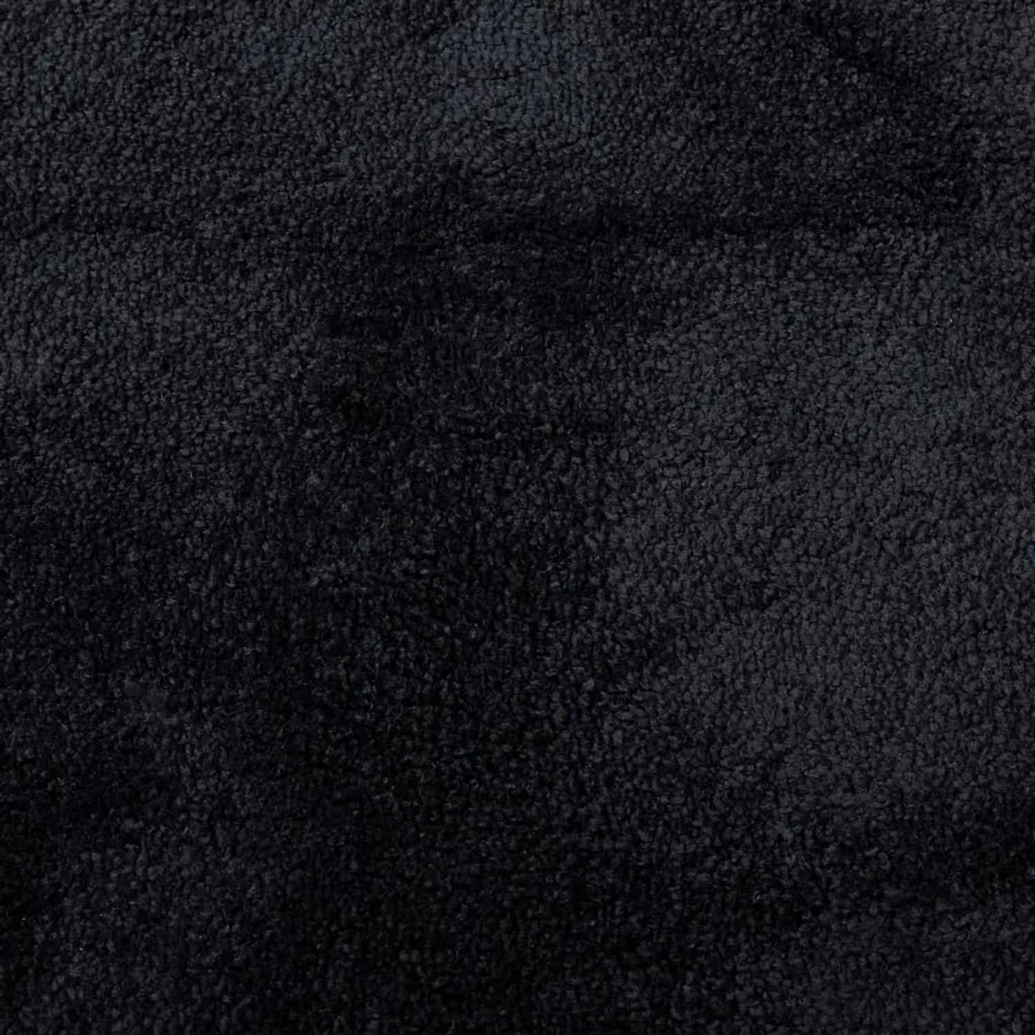 Detailaufnahme: Schwarzer, runder Kurzflorteppich OVIEDO mit weicher Textur.