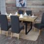 6er-Set Polsterstühle „Crotone“ in Dunkelgrau mit hellen Beinen am Esstisch.
