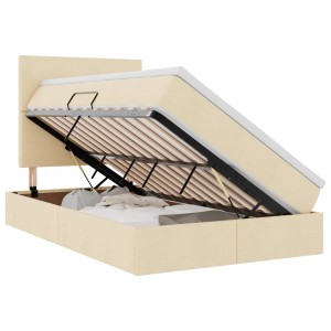 Offenes creme-farbenes Stoffbett (120x200) mit LED-Leisten und Stauraum unter der Matratze.