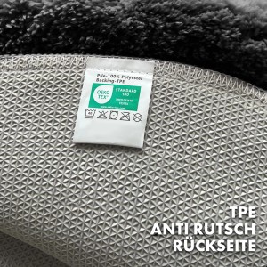 Detailaufnahme der rutschfesten Rückseite der schwarzen, runden KARAT Badematte SKY mit Öko-Tex Zertifikat.