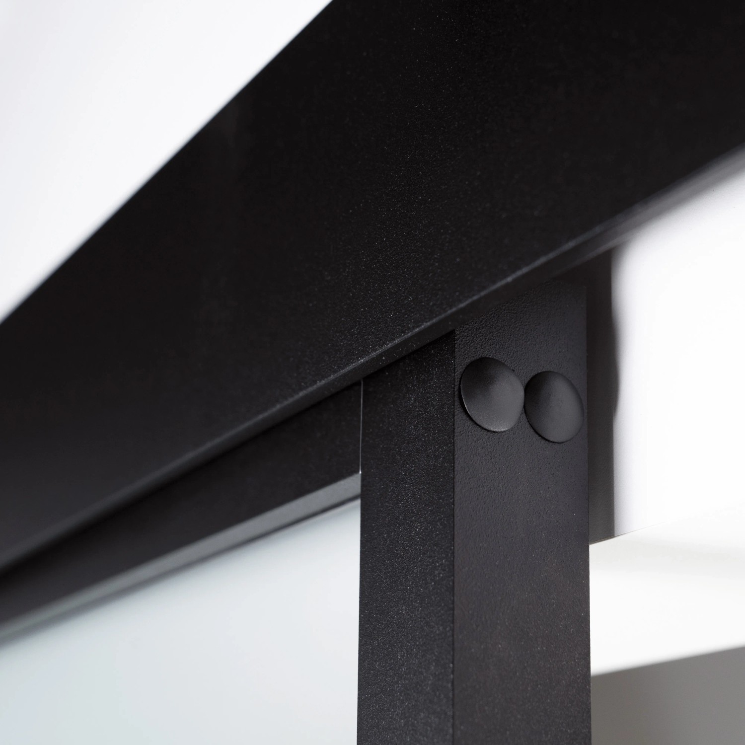Detailaufnahme: Schwarzer Rahmen der Loft+Mehr Schiebetür aus Glas mit Beschlägen.