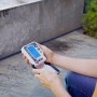 Geka Bewässerungscomputer mit Hahnadapter in der Hand, zur Steuerung der Gartenbewässerung.