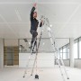 Handwerker auf Leiter mit Bosch Kreuzlinienlaser GCL 2-50 zur Ausrichtung an der Decke.