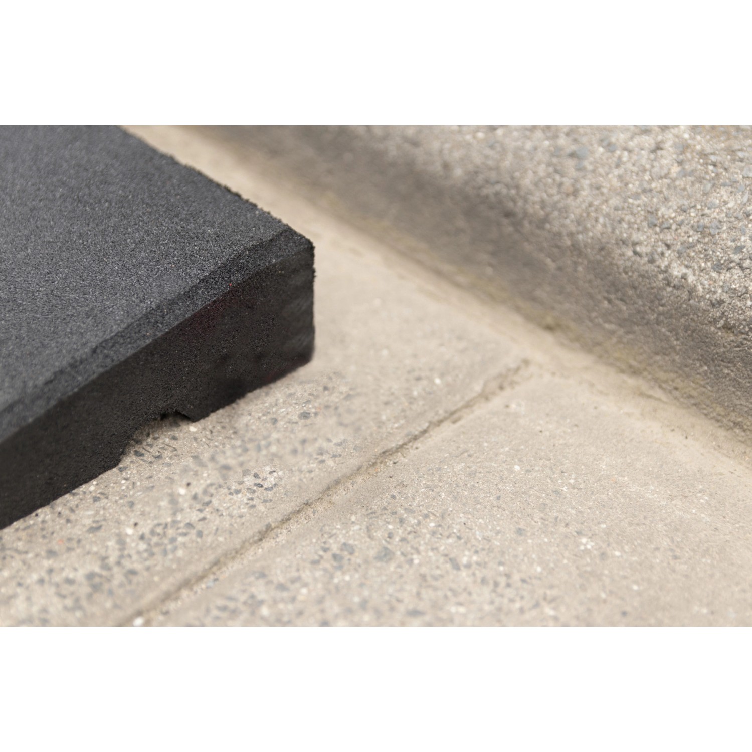 Schwarze Bordsteinrampe aus Gummigranulat, 1000x250x7-45mm, zum einfachen Überfahren von Bordsteinen.