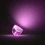 Philips Hue Iris Tischleuchte in Weiß mit farbigem Lichtschein.