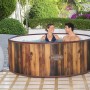 LAY-Z-SPA Helsinki AirJet Whirlpool, rund, 180x66 cm, mit zwei Personen im Wasser, Holzoptik.