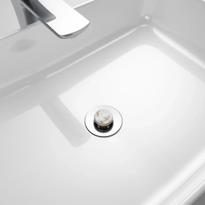Sanilo Pop Up Waschbeckenstöpsel mit Seestern-Motiv in Grau im weißen Waschbecken.