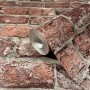 Marburg Vliestapete GZSZ in 3D Steinoptik, rot. Rolle vor einer Wand mit Steinmuster.