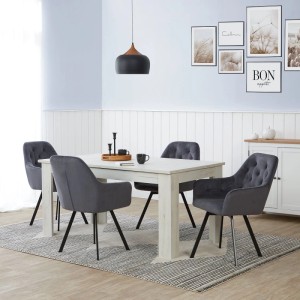 Vier graue drehbare Polsterstühle im 4er Set mit Samtbezug und schwarzen Metallfüßen an einem Esstisch.