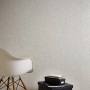 A.S. Création Vliestapete Greenery Uni meliert Grau an Wand, mit Stuhl und Boxen im Raum.