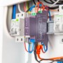 Shelly Pro 2 Relaismodul (2-Kanal, 25A) in Grau, montiert im Verteilerkasten für Hausautomation.