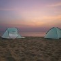 Zwei Pavillo Strandmuscheln Beach Quick 2 Tent am Strand bei Sonnenuntergang.