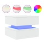 Weißer Couchtisch mit moderner, schwebender Optik und blauer LED-Beleuchtung. Oben sind weitere RGB-Farboptionen sichtbar.
