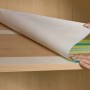 Anwendung von Tesa doppelseitigem Klebeband (10 m x 50 mm) auf einem Regal.
