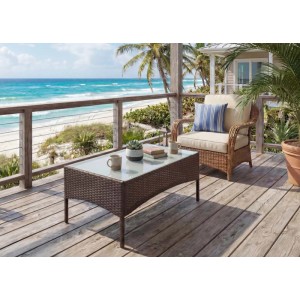 MCW Poly-Rattan Gartentisch Hamar, braun-meliert, mit Glasplatte auf Holzterrasse am Meer.