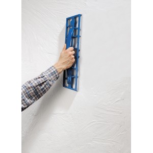 LUX Gipserhobel 50 cm im Einsatz: Hand hobelt Gips an einer weißen Wand. Ideal für Trockenbauarbeiten.