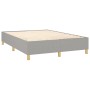 Helles, graues Boxspringbett 140x190 cm mit Holzlattenrost und Füßen.