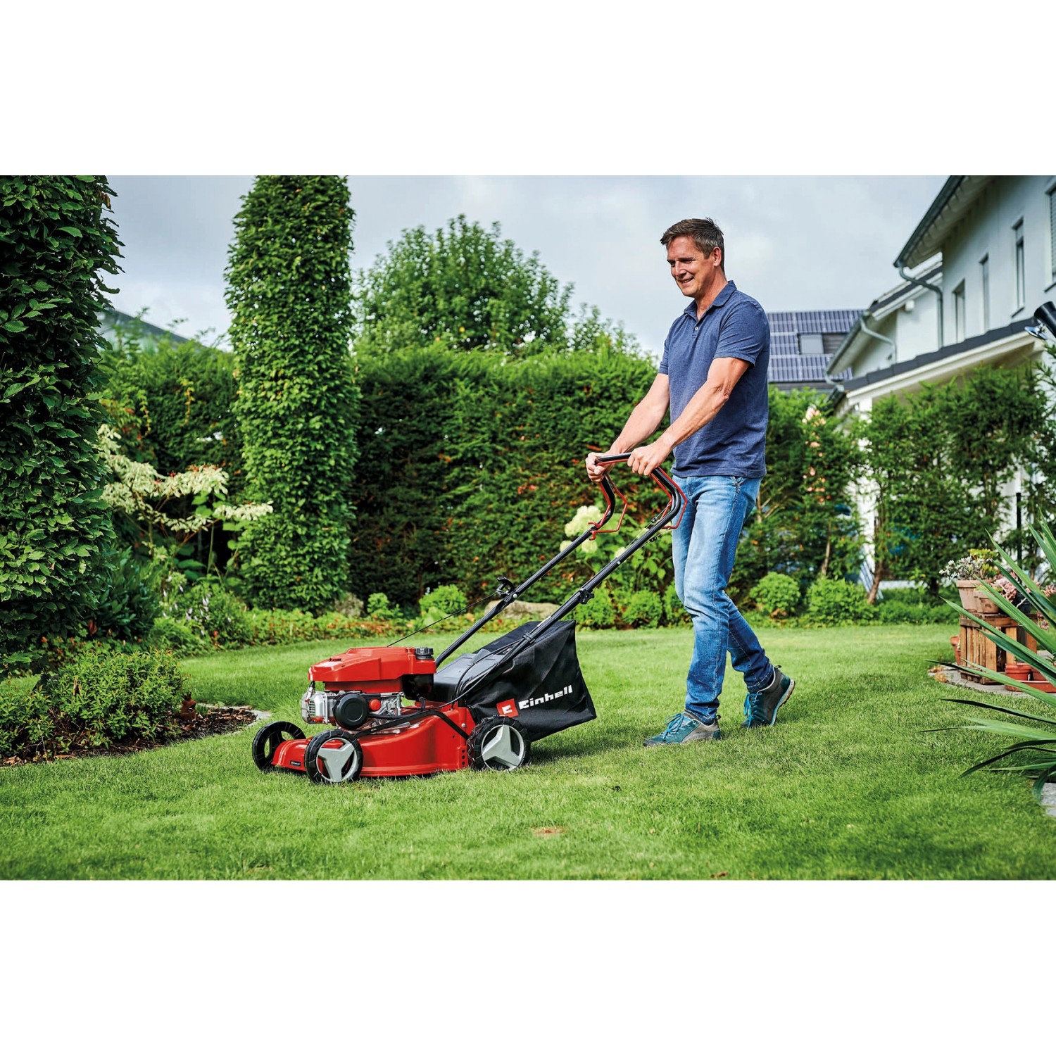 Einhell Benzin-Rasenmäher GC-PM 40/2 S im Einsatz auf Rasenfläche.