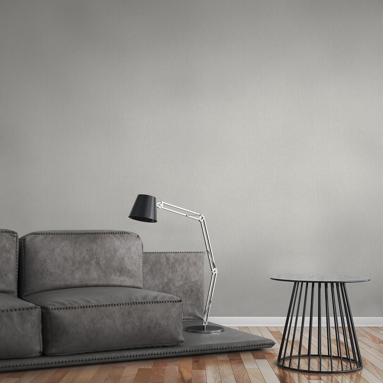 A.S. Création Vliestapete Uni Grau an Wand im Wohnraum, kombiniert mit Sofa und Lampe.