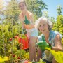 Zwei Frauen im Garten nutzen graue, klappbare Rankhilfen für Tomatenpflanzen. Robuste Pflanzenstützen aus Eisen/Kunststoff.