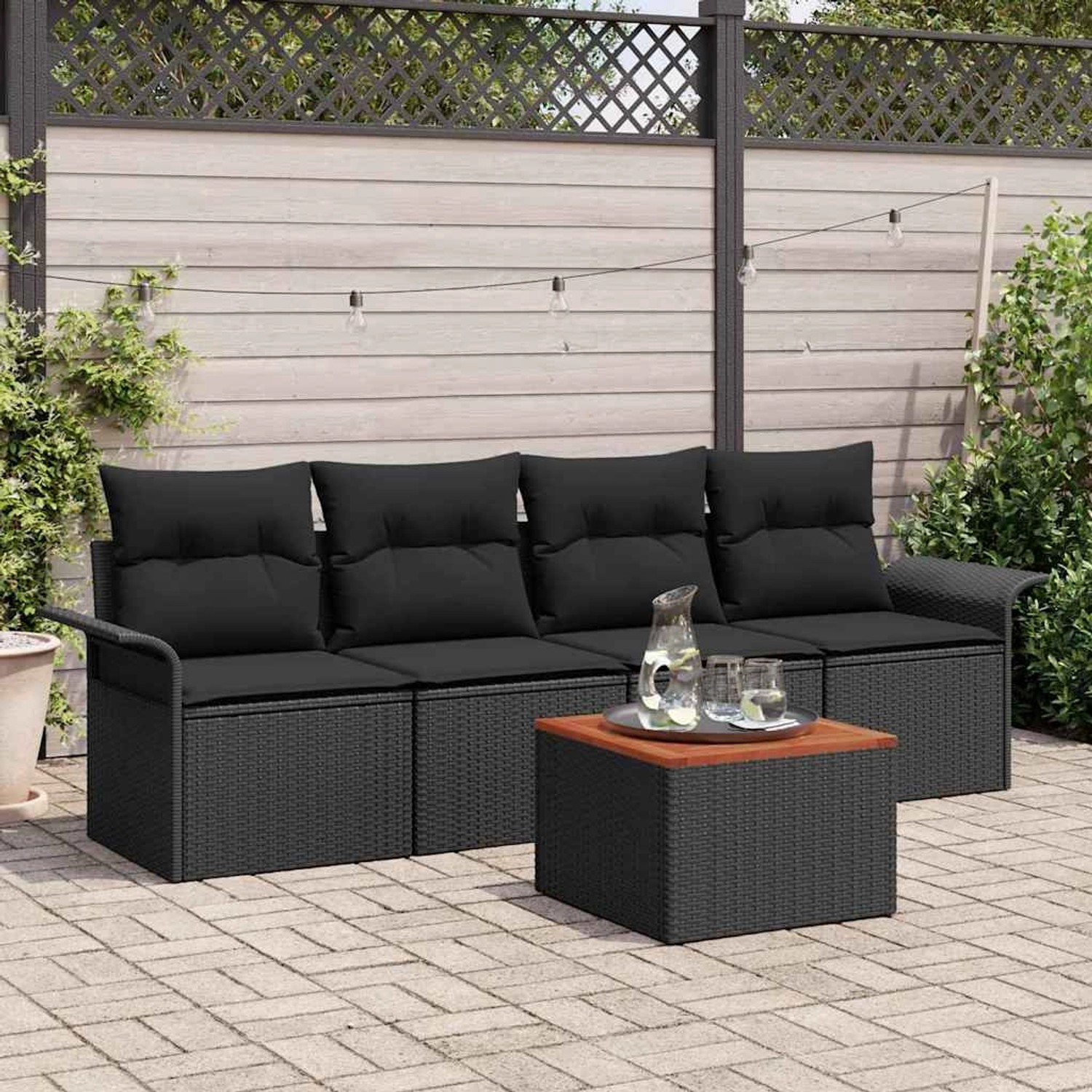 Schwarzes 5-tlg. Garten-Sofa-Set aus Poly Rattan mit Tisch für Terrasse und Garten.