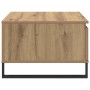 Quadratischer Couchtisch Artisan-Eiche aus Holzwerkstoff mit integrierter Schublade und schwarzem Metallgestell.