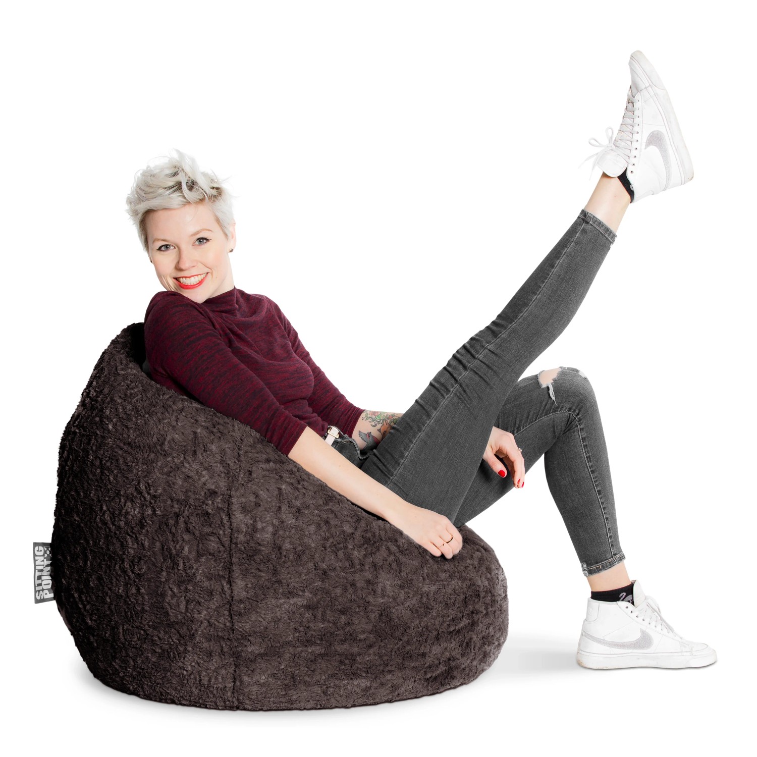 Frau entspannt im anthrazitfarbenen Sitting Point Sitzsack Fluffy 220 l.