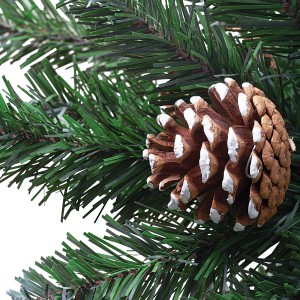 Detailaufnahme: Künstlicher Tannenbaum Kiefer Blavand mit Schnee und Zapfen.