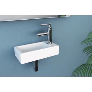 Weißes, extra kleines NEG Hänge-Waschbecken Uno41H mit Armaturloch rechts, an blauer Wand. Ideal für Gäste-WC.