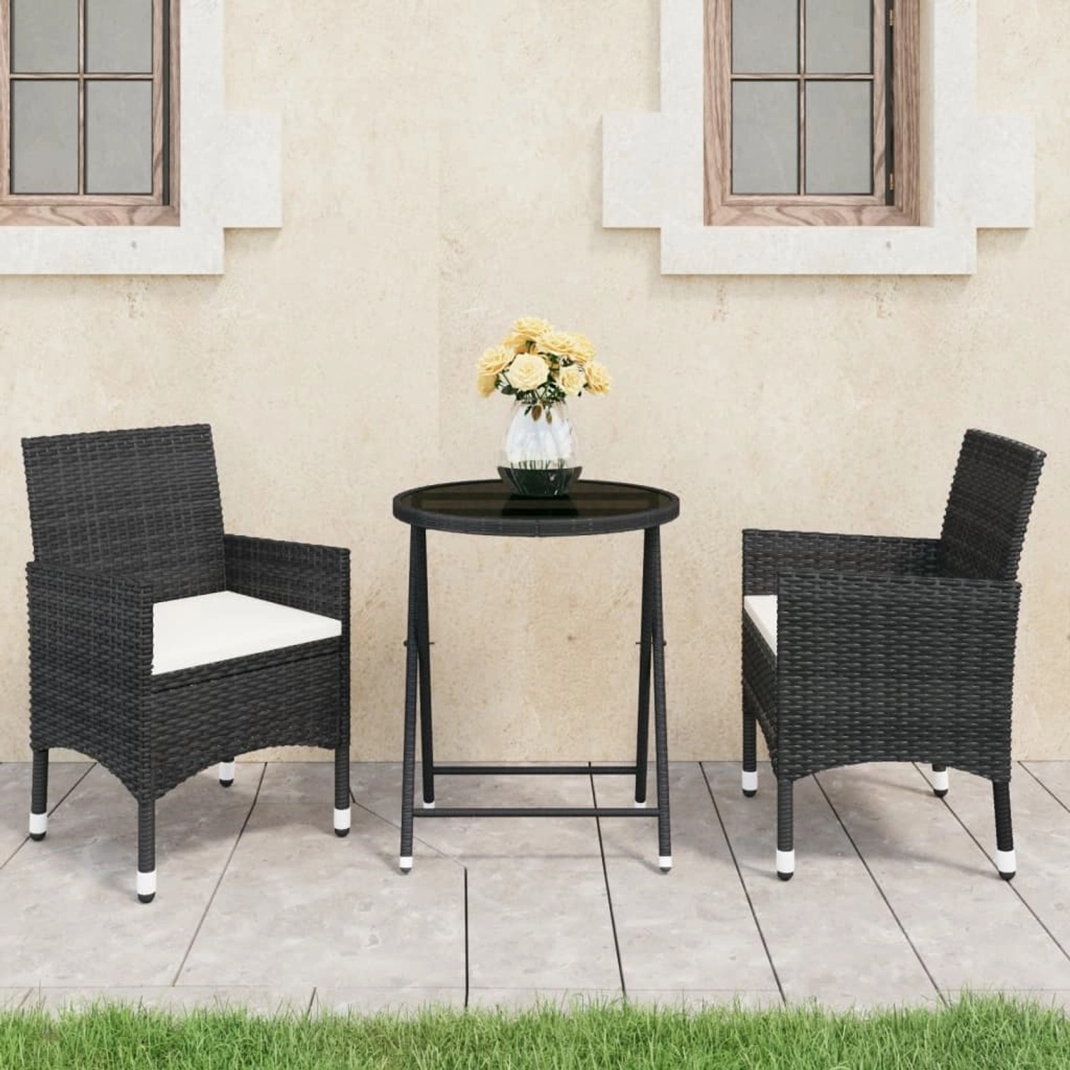 Schwarzes 3-tlg. Bistro-Set aus Poly-Rattan mit Glasplatte und 2 Stühlen mit creme-farbenen Kissen.