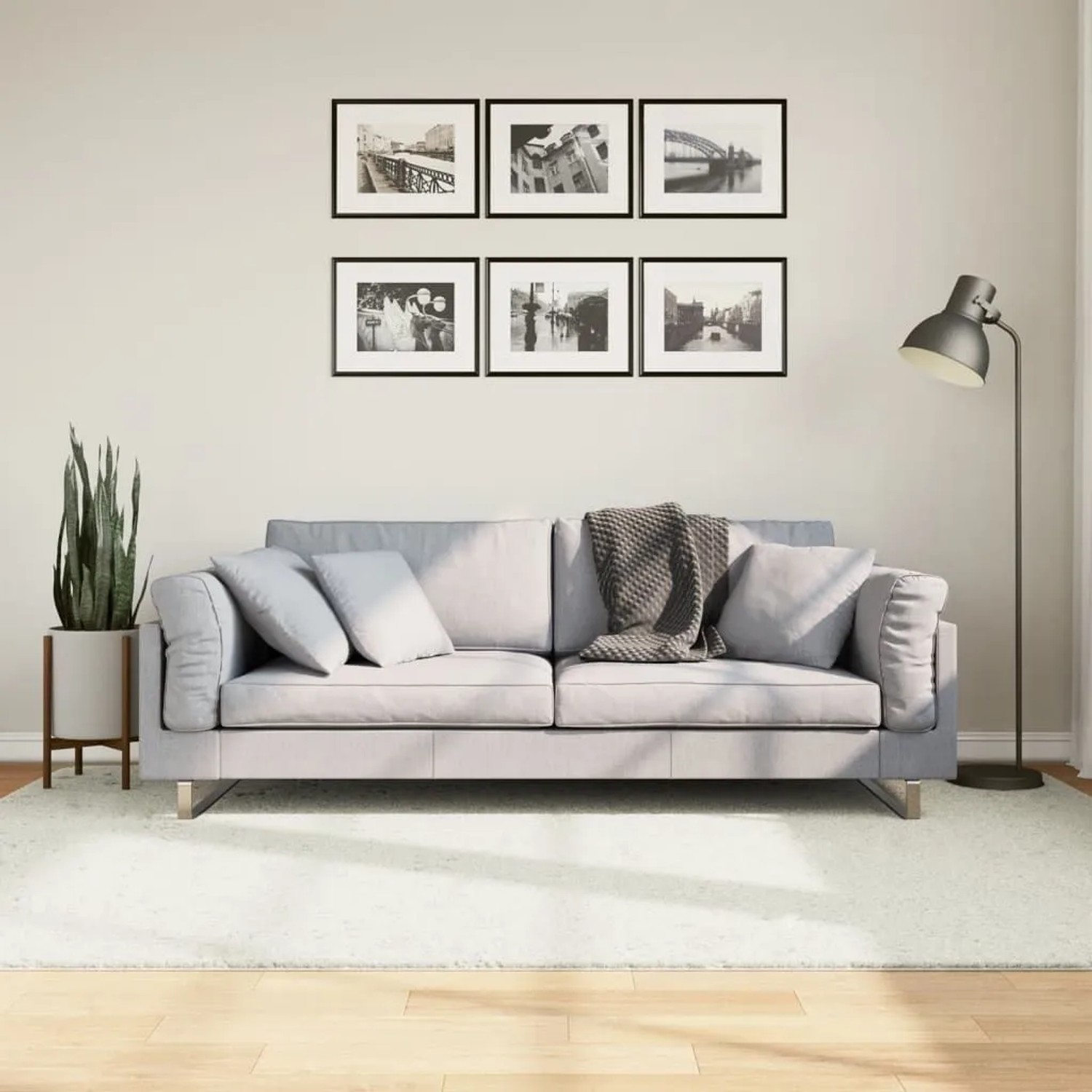Cremefarbener vidaXL Oviedo Kurzflorteppich (160x230 cm) im Wohnzimmer unter Sofa auf Holzfußboden.