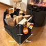 Schwarze KARAT Filztasche Vesta als Kaminholztasche mit Holzgriffen, gefüllt mit Holzscheiten.