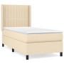 Cremefarbenes Boxspringbett 80x200 cm mit Matratze und Kopfteil aus Stoff.
