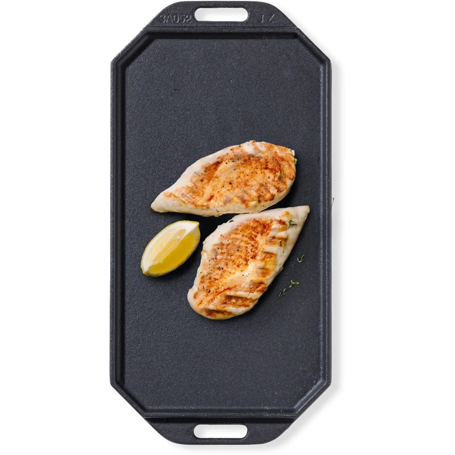 Rechteckige Cozze Gusseisenpfanne mit Grillhähnchen und Zitrone, Grillutensil.