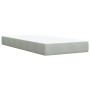 Hellgraues Boxspringbett 90x190 cm mit Matratze und Samtbezug.