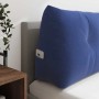 Polizeiblaues Samt-Rückenkissen mit Knopfheftung, Seitentasche und Handy auf einem Bett. Für Komfort.