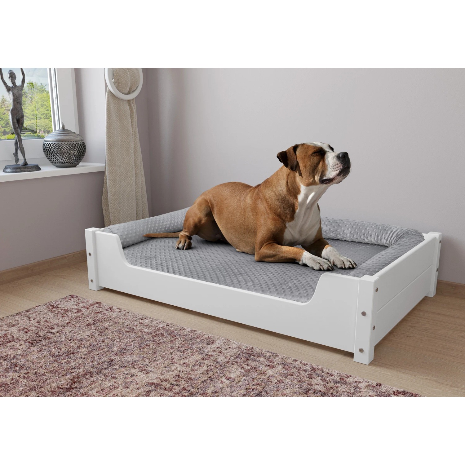 Hund liegt entspannt im weißen Erst-Holz Hundebett 100x60 cm mit Rollrost.