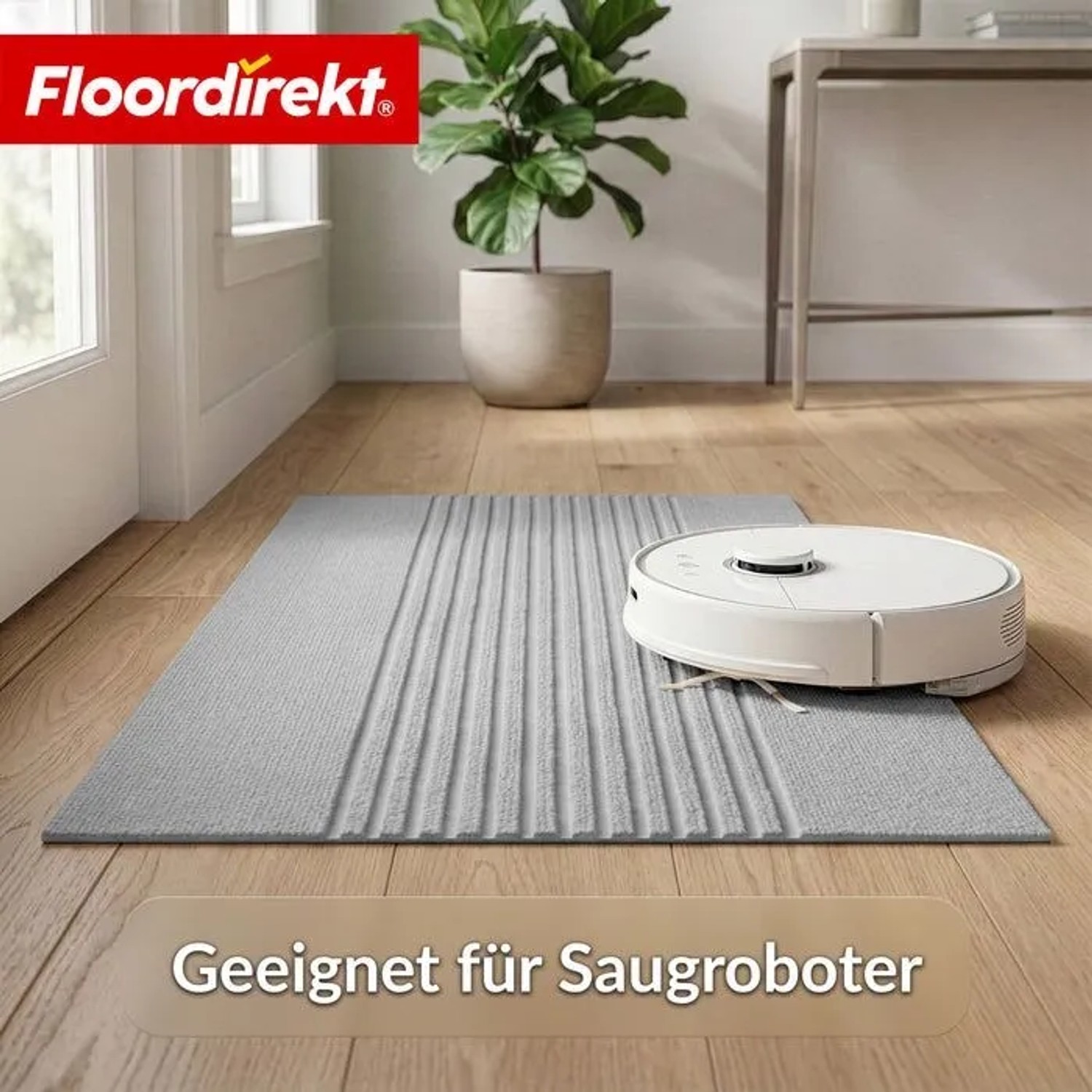 Graue Floordirekt Schmutzfangmatte CIRCA mit Streifen, waschbar, rutschfest, Saugroboter fährt darüber im Flur.