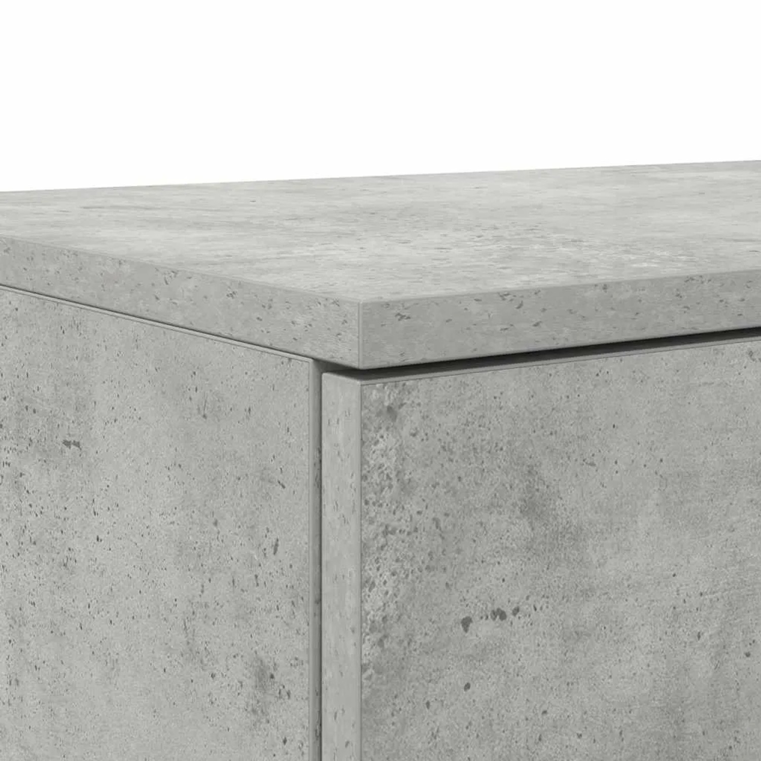 Detailansicht einer betongrauen Bettschublade aus Holzwerkstoff, zeigt die raue Betonoptik und die Kante.