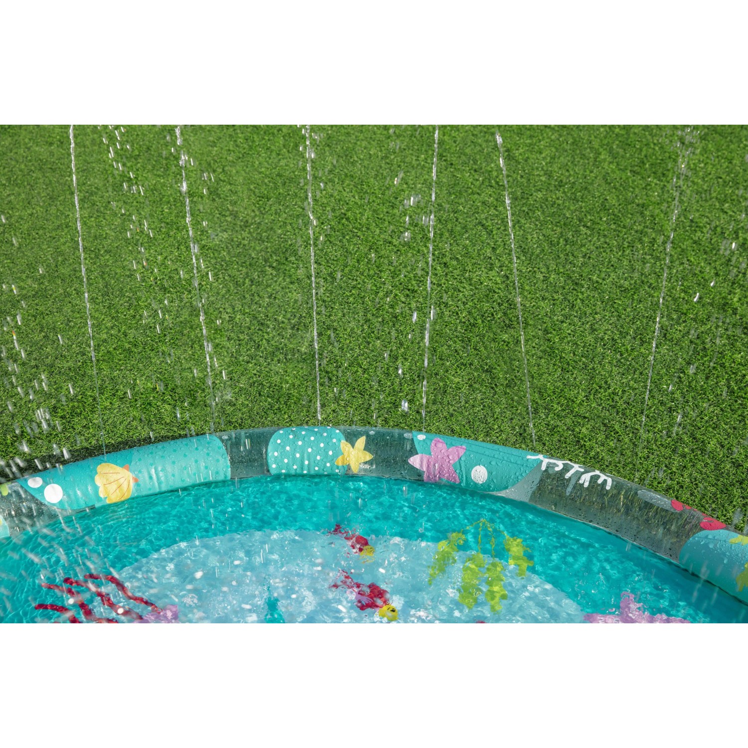 Bestway Wassermatte Underwater Ø 165 cm mit bunten Meeresmotiven und Wassersprinklern im Garten.