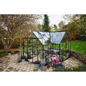 Halls Gewächshaus Icon Gardenhouse 8, 13 m², grün, mit Pflanzen und Gartenmöbeln.
