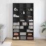 Hohes, schwarzes CD Regal in Eichen-Optik mit vielen Fächern für CDs, DVDs und Deko im Wohnzimmer.