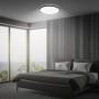 Schwarzes Brilo LED-Panel Slim Sternenhimmel, neutralweiß, Ø 37,5 cm, montiert in einem Schlafzimmer.