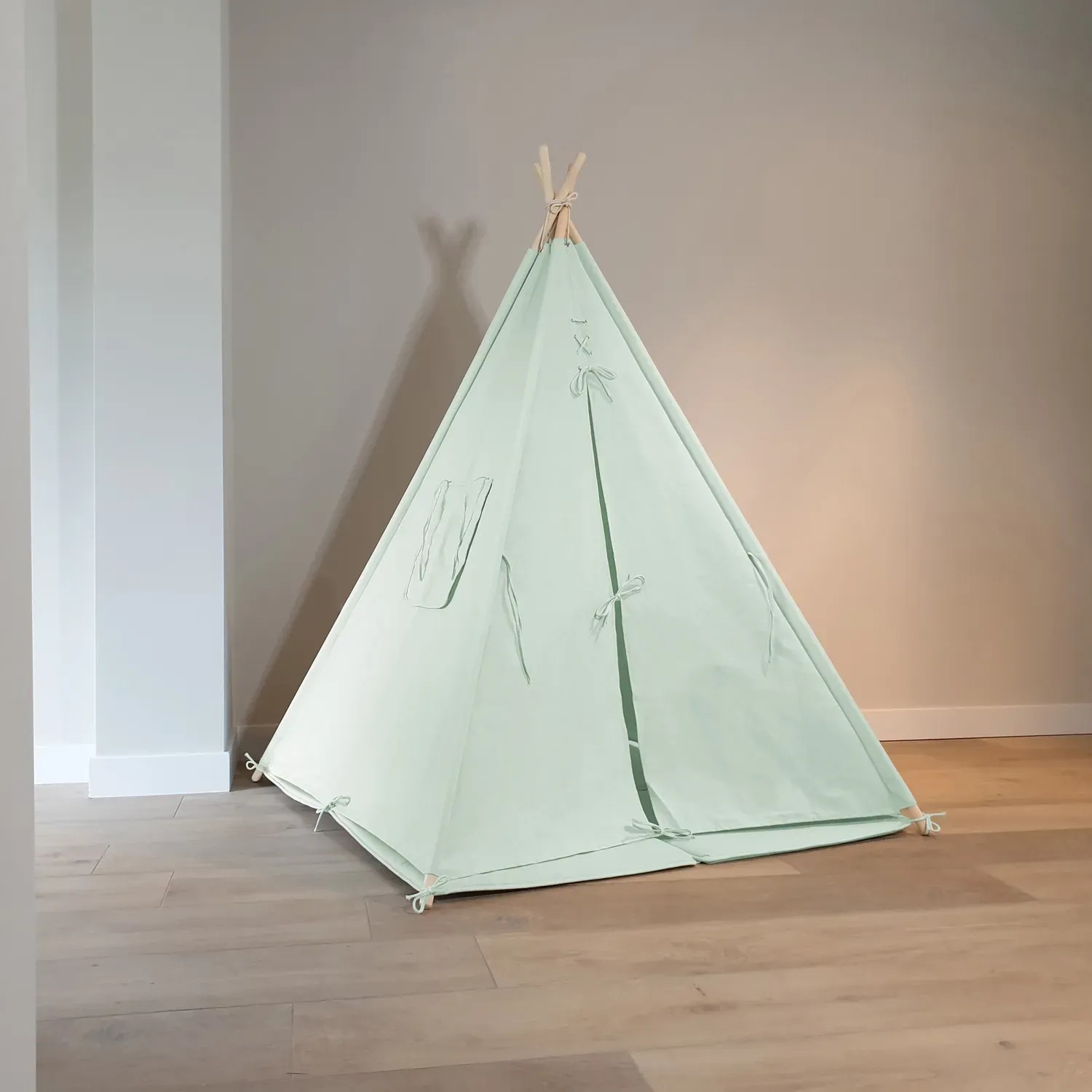 Pastellgrünes Sunny Tipi Zelt Alba aus Baumwolle mit Holzstäben für Kinder zum Spielen.