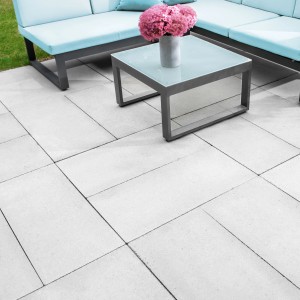 Diephaus Gehwegplatten Zementgrau 60x40 cm auf Terrasse mit Möbeln.